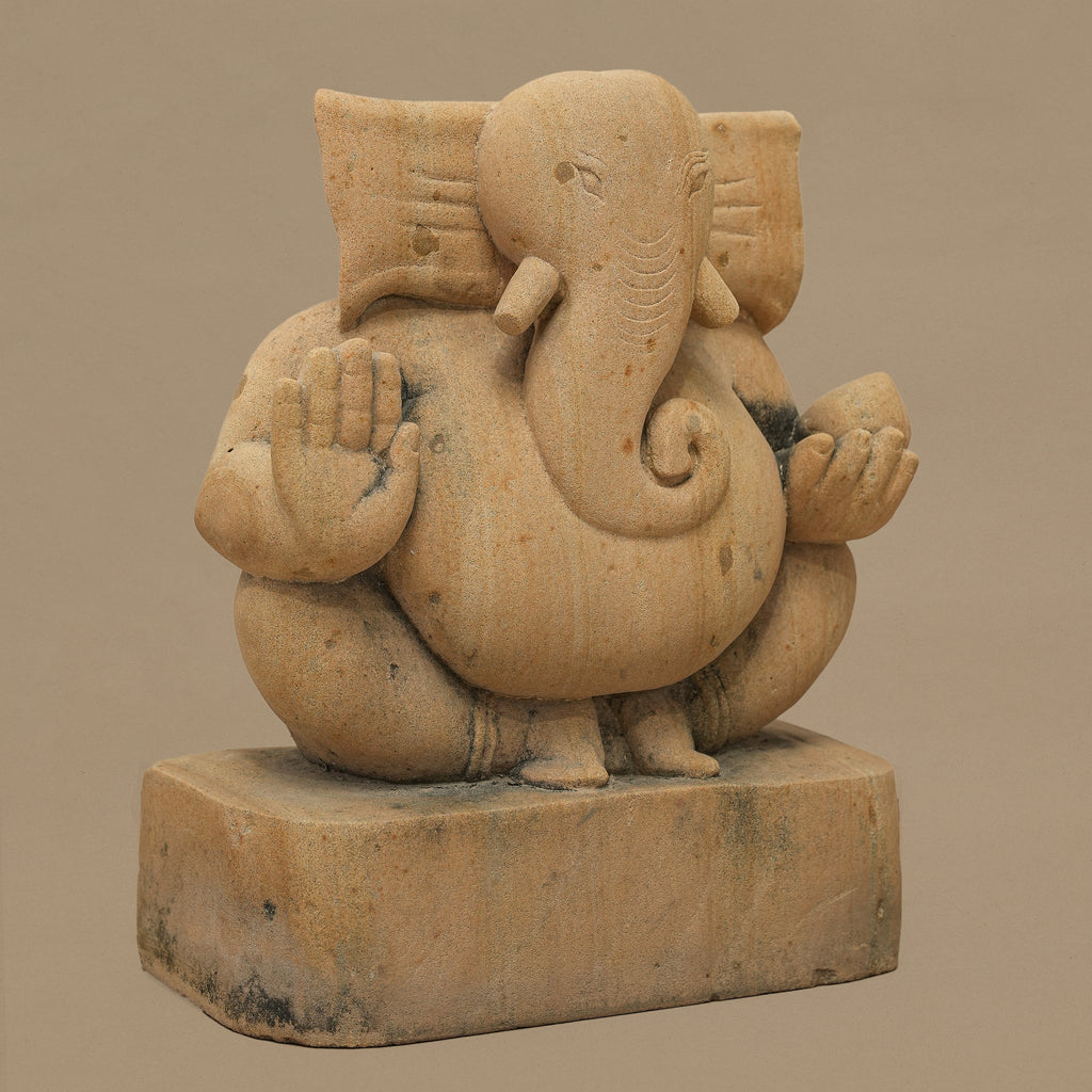 Left angle view of 11 inch Lord Ganesh statue handcrafted in yellow sandstone