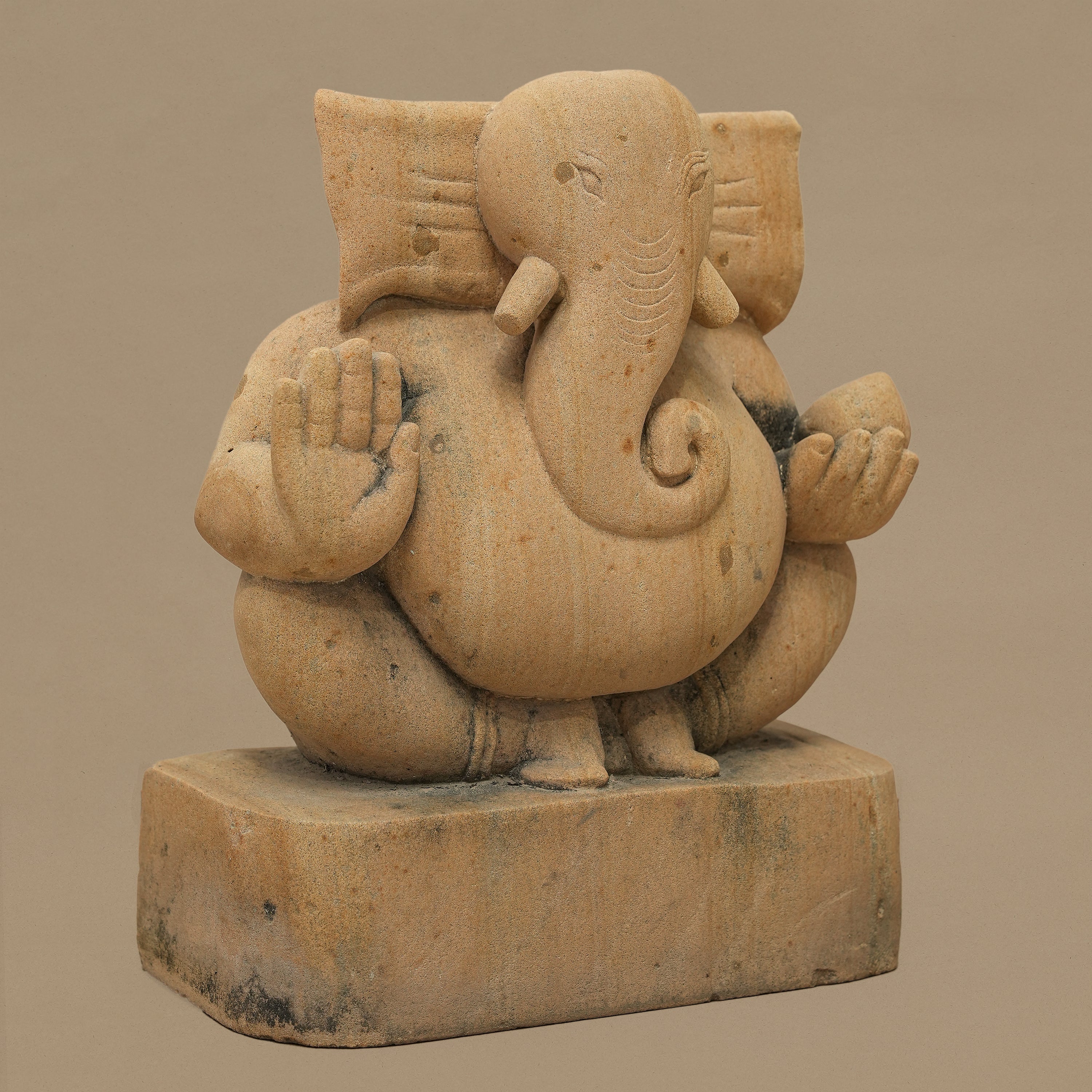 Left angle view of 11 inch Lord Ganesh statue handcrafted in yellow sandstone